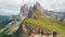 Tourists stand on viewpoint over valley looking at mountain