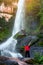Tourists standing at the Beautiful Tat Pho waterfall is originated from Phu Langka Mountain Range