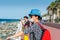 Tourists standing at the crescent road and looking at the sea in the Palm Jumeirah island in Dubai of the United Arab Emirates