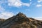 Tourists standing on the edge of cliffs and rocks while taking photos on the top of Seceda in Dolomites, South Tyrol, Italy