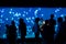 Tourists stop and observe a tank full of jellyfish in an aquarium