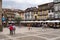 Tourists stroll in Largo da Oliviera by traditional houses in Guimaraes in Portugal