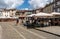 Tourists stroll in Sao Tiago square by traditional houses in Guimaraes in Portugal