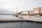 Tourists strolling along the picturesque promenade in the port of the Frioul Islands in Marseille