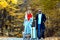 Tourists with suitcase, full length. Autumn couple travel. Autumnal weather. Woman and man holding suitcase baggage