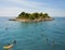 Tourists swim near a small island