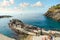 Tourists swim in the sea and sunbathe near the the rocky coastline of Manarola, Italy, part of the Cinque Terre