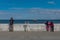 Tourists take photos of the cormorants on an old pier in Punta Arenas, Chile