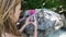 Tourists take photos on their phones of wild crab eating macaques on Monkey Island near Phi Phi