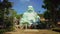 Tourists Take Pictures of Laughing Buddha Statue against Hills