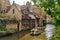 Tourists take a scenic boat tour in the canals of Brugges, Belgium.