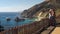 Tourists take a selfie of the big sur coastline looking north
