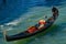 Tourists taking gondola, the traditional Venetian boat, on canal in Venice, Italy