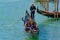 Tourists taking gondola, the traditional Venetian boat, on canal in Venice, Italy