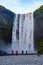 Tourists taking photos near powerfull Skogafoss waterfall in Iceland