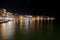 Tourists, taverns and houses at night in the port of Chania city