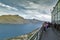 Tourists at the terrace overlooking view of Lake Wakatipu and Queenstown, south island of New Zealand