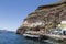 Tourists and tourist ship in the old port in Fira, Santorini,