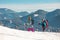 Tourists travel together in the mountains in winter. two girls snow-capped mountains