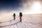Tourists travel together in the mountains in winter. two girls snow-capped mountains