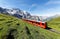 Tourists traveling on a cogwheel train of the famous Jungfrau Railway from Jungfraujoch Top of Europe