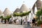 Tourists in trulli town of Alberobello, Italy