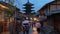Tourists with umbrellas walking past Yasaka Pagoda