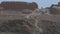 Tourists view the ruins of an ancient city, archaeological excavations in desert