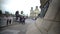 Tourists viewing bronze lion sculpture at Columbus Monument base in Barcelona