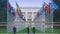 Tourists viewing Palace of Nations in Geneva, alley of UN member countries flags