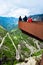 Tourists on the viewpoint over Trollstigen or Troll Stairs, a serpentine mountain road that is popular tourist attraction in