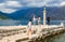 Tourists visit Island of Virgin on reef Gospa od Skrpela Island in Bay of Kotor, Montenegro