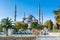 Tourists visiting Blue Mosque,  also called the Sultan Ahmed Mosque or Sultan Ahmet Mosque under sunlight in the morning in autumn