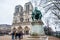 Tourists visiting the Charlemagne Statue and the Notre Dame Cathedral