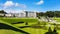 Tourists visiting Powerscourt Gardens, view on mansion from hill