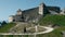 Tourists visiting Rasnov Citadel, Brasov, Romania, hyperlapse pan and zoom out