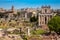 Tourists visiting the Roman Forum and the Temple of Antoninus and Faustina in Rome