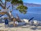 Tourists and visitors taking photos and enjoy the beautiful seaside view of Hydra island, Greece