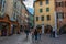 Tourists and visitors walking in the beautiful streets of Annecy town against a cloudy sky. Annecy, Haute Savoie, France