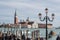 Tourists waiting gondola on San Marco embankment.