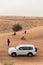 Tourists Waiting and Stop Cars for Sun Down on The Sand Dune of Dubai