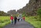 Tourists walk through the Almannagja fault line in the mid-atlantic ridge north american plate in Thingvellir National Park