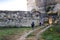 Tourists walk along the ancient ruins and taking photos, tourist theme