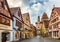 Tourists walk along beautiful streets in Rothenburg ob der Tauber