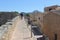 Tourists walk on the ancient city walls in Alcudia, Mallorca, Spain