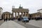 Tourists walk through and around the Brandenburg Gate on Unter den Linden in central Berlin