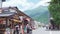 Tourists walk around Yufuin`s main shopping street