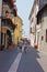 Tourists walk on Bardolino street, near the Garda Lake shore.