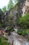 Tourists walk the bridge over the stream. Honey waterfalls