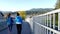 Tourists walk on the bridge to Rocky point park